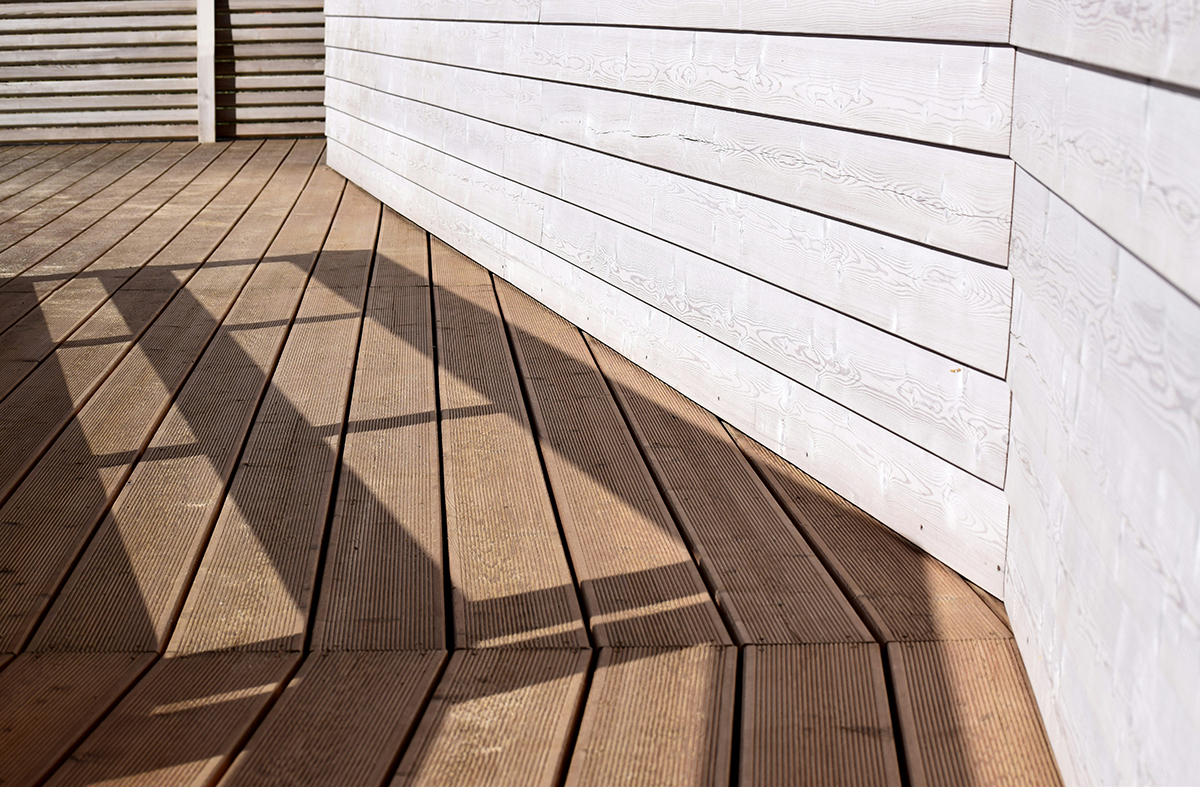 Vue rapprochée d’une terrasse bois avec lames rainurées et structure en lambourdes, illustrant les principes de pose et d’alignement des entraxes pour un platelage durable et esthétique.